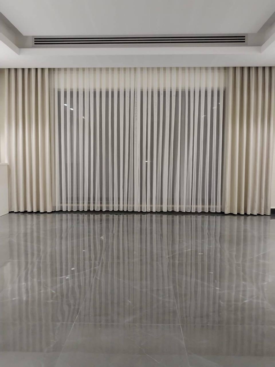 Custom Roman shades in soft beige linen fabric with decorative trim